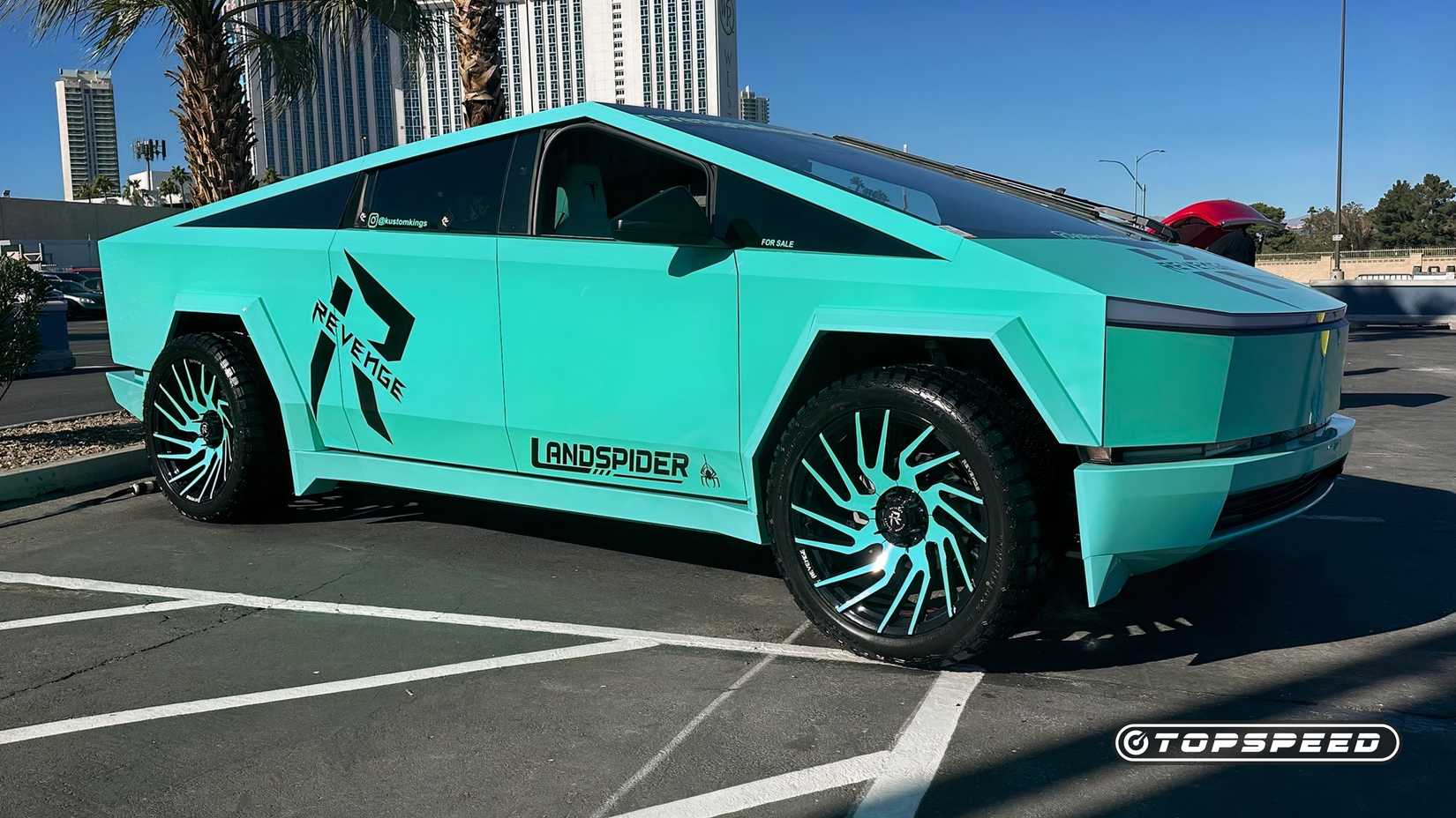 A Passenger's Side View Of A Tesla Cybertruck With Custom Wheels And Wrap.