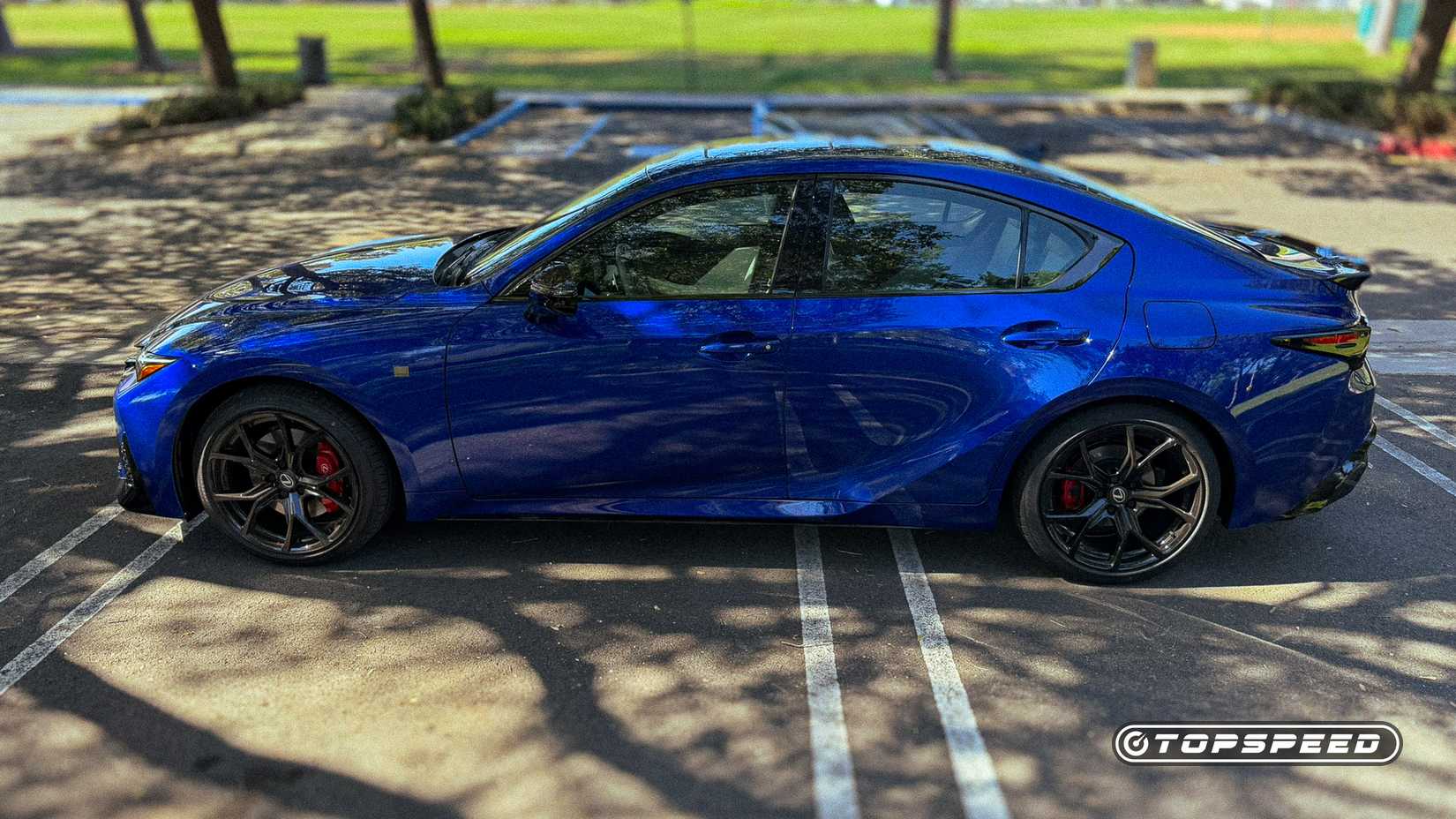 Blue 2026 Lexus IS 350 F Sport side shot parked in the lot
