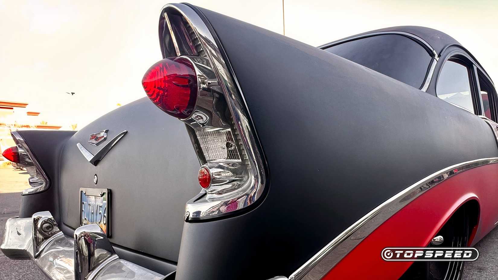 A black and red 1956 Chevy 210 Tri-Five taillight close-up
